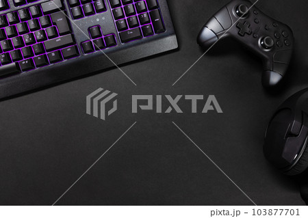 Purple lit keyboard by game controller and mouse Purple lit keyboard by game controller and mouse 103877701