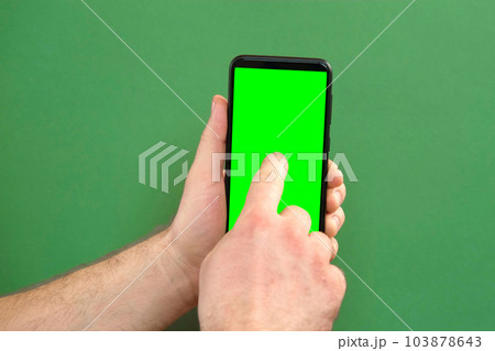 Young man hand use smartphone with green screen on green background. Gestures pack. Male hand touching, clicking, tapping swiping on black phone chroma key display. Close up Device. Modern Technology 103878643