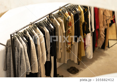 Women's casual demi - season clothes on a hanger in the shop 103882412