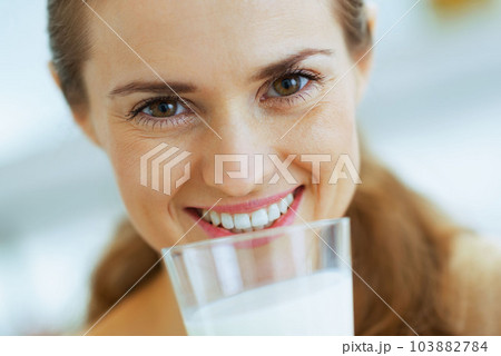 Happy young woman drinking milk Happy young woman drinking milk 103882784