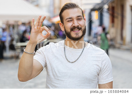 Happy cheerful man guy showing ok gesture, positive like sign, approve something good, celebrate 103884084
