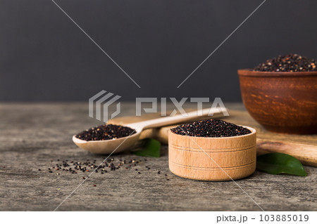 quinoa seeds in bowl and spoon on colored background. Healthy kinwa in small bowl. Healthy superfood 103885019