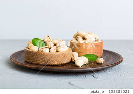 Fresh healthy Pistachios in bowl on colored table background. Top view Healthy eating concept. Super foods Fresh healthy Pistachios in bowl on colored table background. Top view Healthy eating concept. Super foods 103885021