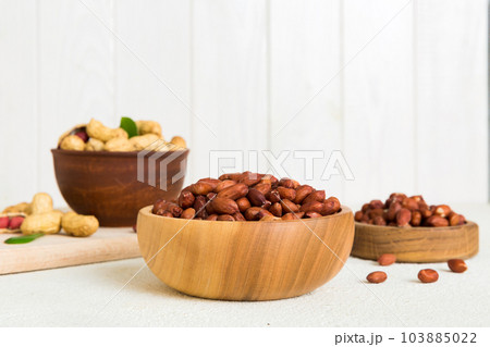 Fresh healthy peanuts in bowl on colored table background. Top view Healthy eating bertholletia concept. Super foods Fresh healthy peanuts in bowl on colored table background. Top view Healthy eating bertholletia concept. Super foods 103885022