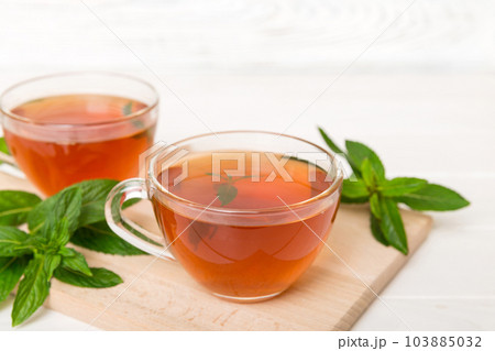 Cup of mint tea on table background. Green tea with fresh mint top view with copy space 103885032