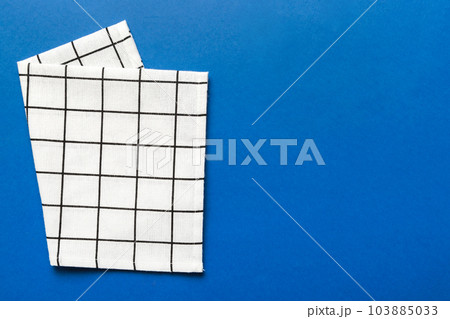top view with white empty kitchen napkin isolated on table background. Folded cloth for mockup with copy space, Flat lay. Minimal style top view with white empty kitchen napkin isolated on table background. Folded cloth for mockup with copy space, Flat lay. Minimal style 103885033