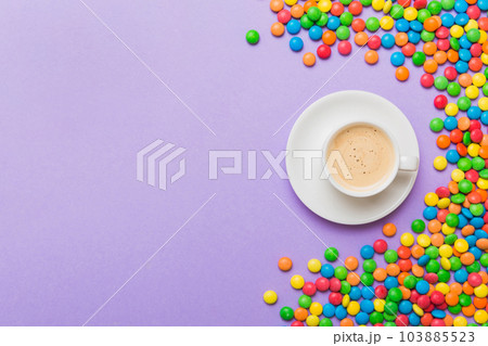 Coffee cup with chocolates and colored candy. Top view on table background with copy space 103885523