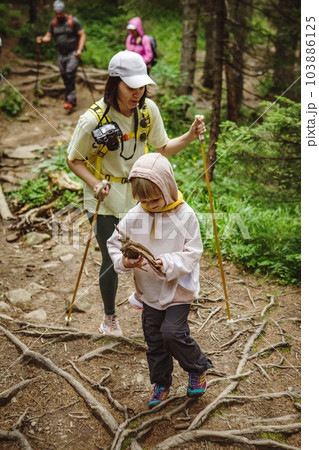 Family on a hike in the forest 103886125