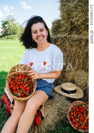 Portrait of Smiling Woman with Basket of Strawberries 103886173