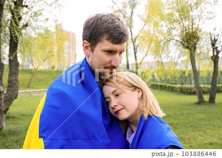 Young people together with the Ukrainian flag outdoors in the park. Free lifestyle Young people together with the Ukrainian flag outdoors in the park. Free lifestyle 103886446