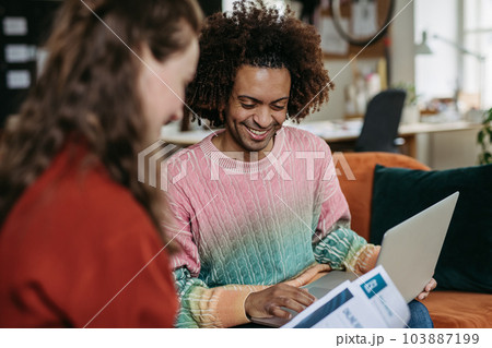 Young colleagues working together in startup company. Young colleagues working together in startup company. 103887199