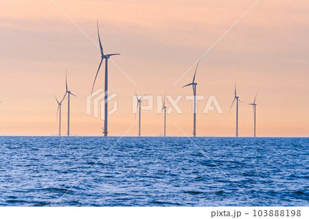 Offshore Windmill farm. windmills isolated at sea on a beautiful bright day Netherlands 103888198