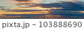 golden clouds after sunset on a dark blue sky 103888690