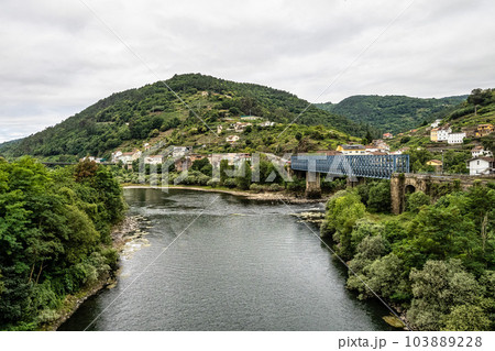 View of the village of Os Peares, Ourense, Galicia in Spain, where the Sil and Mino rivers converge. 103889228