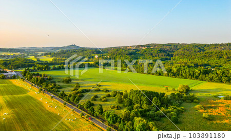 Panoramic landscape of Bohemian Paradise at sunrise time on sunny day. With Trosky castle ruins and Hruba Skala castle and sandstone rocks, Czech Republic. Aerial view from drone. 103891180