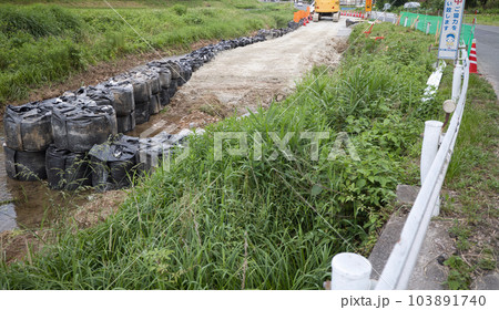 河川の護岸工事 大雨による被害を受けた道路沿いの洗掘防止工事 河川の護岸工事 大雨による被害を受けた道路沿いの洗掘防止工事 103891740
