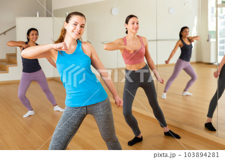 Group of smiling women training sport dance Group of smiling women training sport dance 103894281