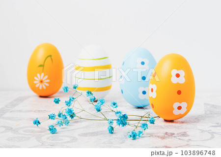 Easter. Multicolored eggs. Yellow and blue Easter decorations. 103896748