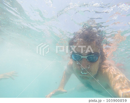 Underwater view of a man swimming in the sea 103900859