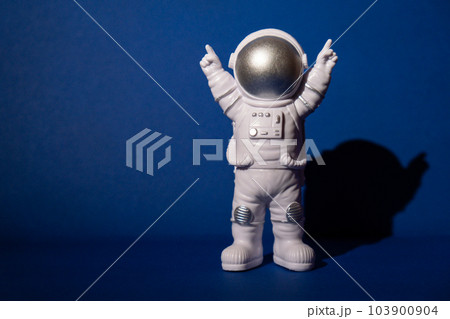 Plastic toy astronaut on colorful blue background Copy space. Concept of out of earth travel, private spaceman commercial flights missions and Sustainability Plastic toy astronaut on colorful blue background Copy space. Concept of out of earth travel, private spaceman commercial flights missions and Sustainability 103900904