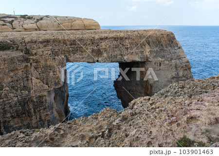 Wied il Mielah canyon, natural arch over the sea. Gozo, Malta 103901463