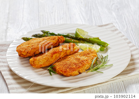 breaded chicken breasts with asparagus and lime breaded chicken breasts with asparagus and lime 103902114