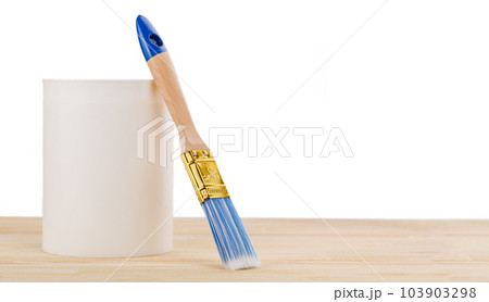 white paint with a brush on a wooden background with texture 103903298