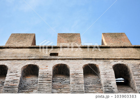 Old brick wall with arrow slit for archers Old brick wall with arrow slit for archers 103903383