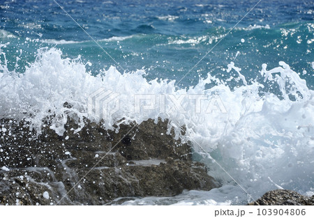 Sea waves crushing the shore 103904806