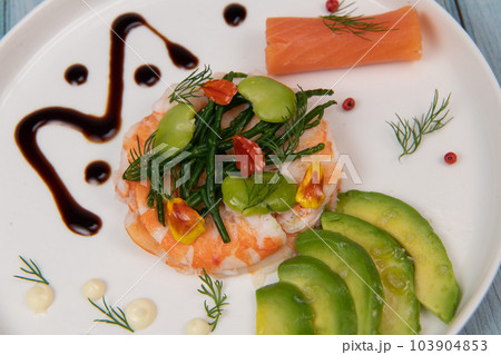 Fish Appetizer shrimp carpaccio, smoked salmon, avocado, samphire in white round plate Fish Appetizer shrimp carpaccio, smoked salmon, avocado, samphire in white round plate 103904853