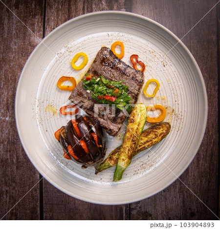 Grilled steak with chimichurri sauce and vegetables 103904893