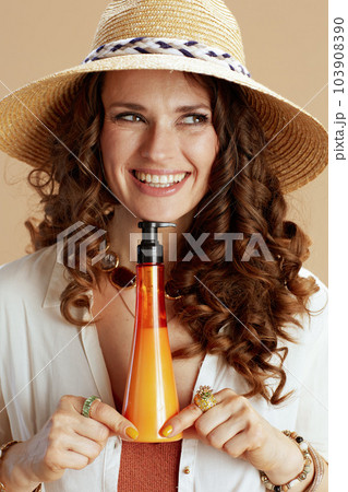 happy elegant woman in blouse and shorts on beige 103908390