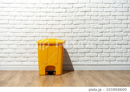 Plastic waste bin with a lid in the room Plastic waste bin with a lid in the room 103908600
