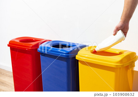 A man throws garbage into the trash can close up A man throws garbage into the trash can close up 103908632
