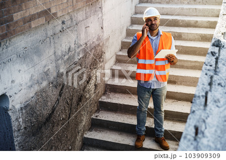 Portrait of young construction engineer wearing hardhat 103909309
