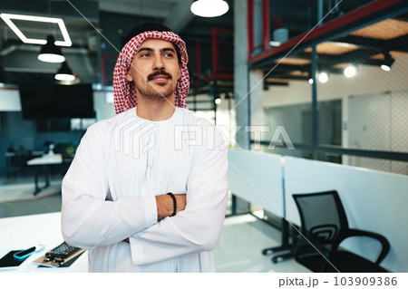 Successful muslim businessmen in traditional outfit in his office Successful muslim businessmen in traditional outfit in his office 103909386