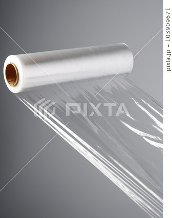 Roll of transparent polyethylene cling film on gray background Roll of transparent polyethylene cling film on gray background 103909671