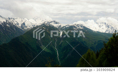 A panoramic view on the snow-capped peaks. Greater Caucasus Mountain Range A panoramic view on the snow-capped peaks. Greater Caucasus Mountain Range 103909824