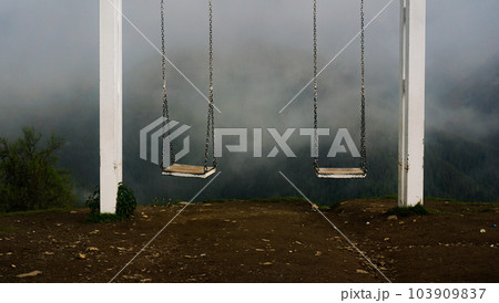The sight of Svaneti - swing in mountains. Empty swing against foggy mountains The sight of Svaneti - swing in mountains. Empty swing against foggy mountains 103909837
