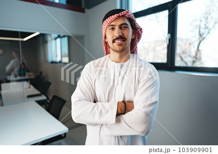 Successful muslim businessmen in traditional outfit in his office Successful muslim businessmen in traditional outfit in his office 103909901