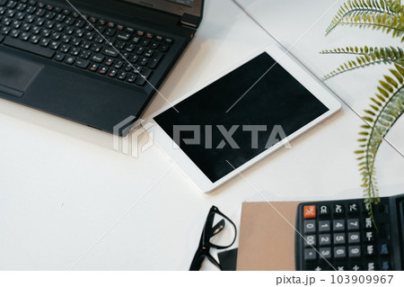 Laptop computer, digital tablet and calculator on office desk Laptop computer, digital tablet and calculator on office desk 103909967