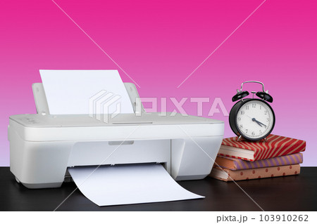 Compact home laser printer against pink background 103910262
