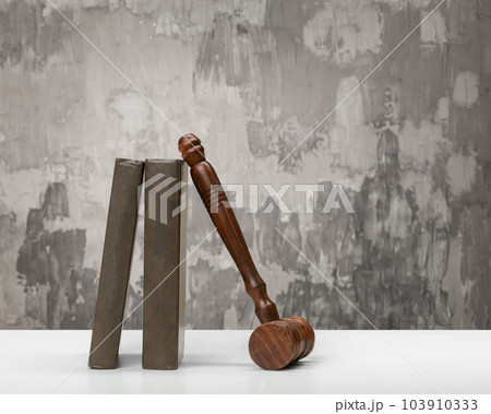 Wooden gavel and books on wooden table Wooden gavel and books on wooden table 103910333