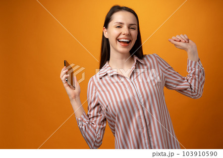 Portrait of a satisfied casual girl celebrating success Portrait of a satisfied casual girl celebrating success 103910590