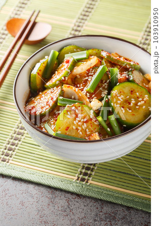Oi muchim is a Korean spicy cucumber salad closeup on the bowl. Vertical 103910950