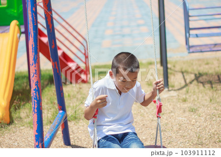 Cute asian child having fun at playground. 103911112
