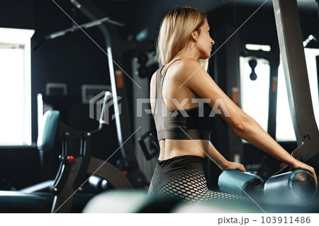 Fitness woman in sport outfit exercising in gym Fitness woman in sport outfit exercising in gym 103911486