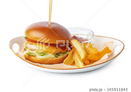 Burger and potato wedges on plate isolated on white background 103911843