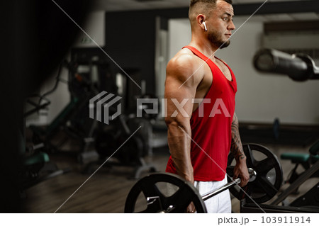 Strong man athlete exercise in gym, close up portrait Strong man athlete exercise in gym, close up portrait 103911914