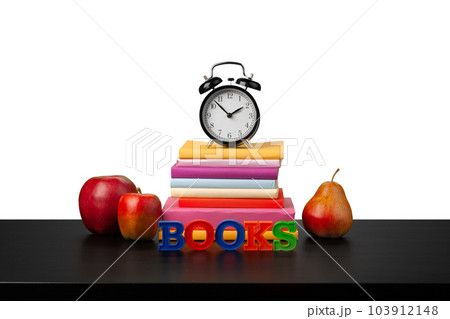 Stack of books and alarm clock, time to read concept Stack of books and alarm clock, time to read concept 103912148
